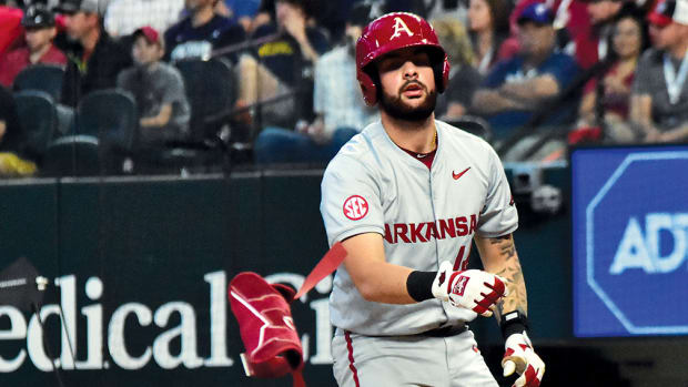 Parker Rowland flips away his elbow guard before taking his base against Michigan.
